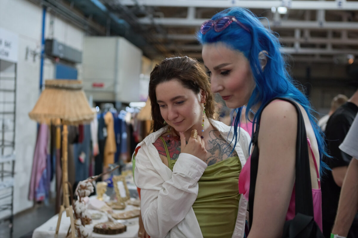 two young women looking at items in a thrift shop