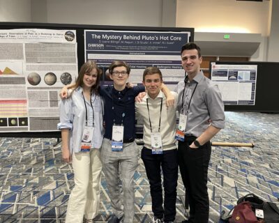 group photo of students in front of their booth