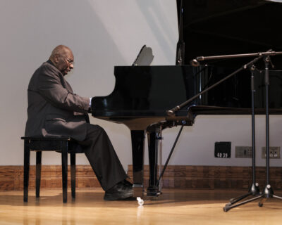 Photo of Oliver Jones playing the piano at Dawson