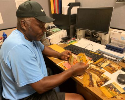 Joel at his desk in the Athletics department. 