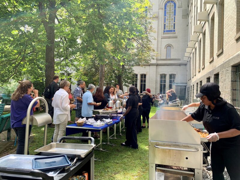 Employees gather for lunch in the courtyard of 3C.1 on a nice summer day.