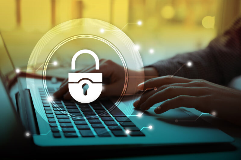 Cyber security concept. Illustration of lock and woman working with laptop at table, closeup