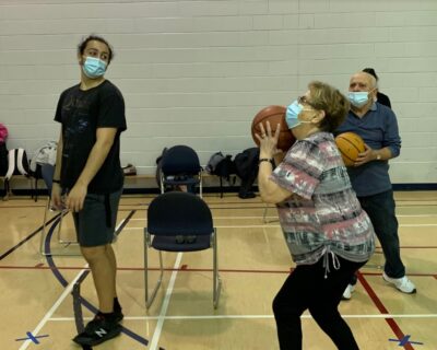 A senior practices shooting hoops.