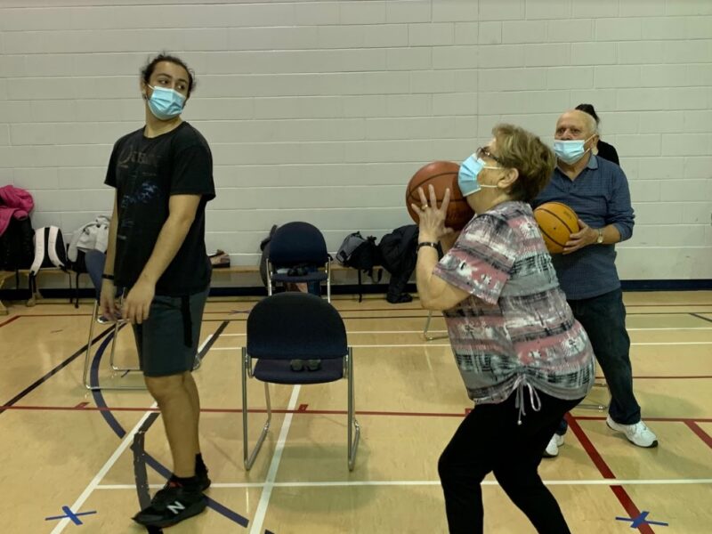 A senior practices shooting hoops.