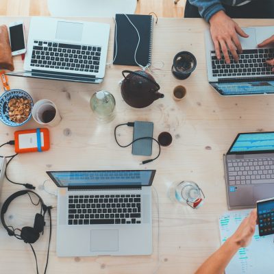 many computer on the table with other devices