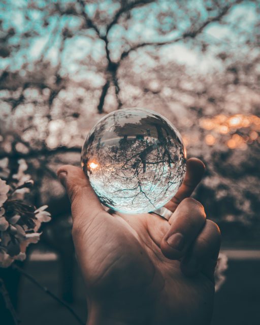 Hand holding a glass ball